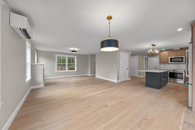 kitchen featuring decorative light fixtures, a kitchen island, stainless steel appliances, and light hardwood / wood-style flooring