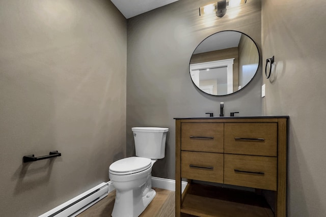 bathroom with baseboard heating, vanity, wood-type flooring, and toilet