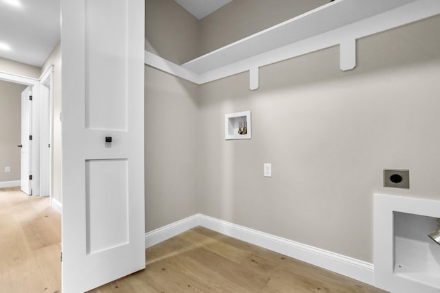 clothes washing area with hookup for an electric dryer, hookup for a washing machine, and hardwood / wood-style flooring