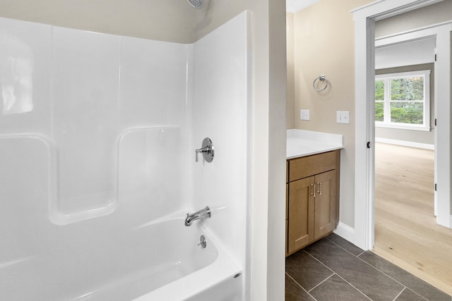 bathroom with hardwood / wood-style floors, vanity, and  shower combination