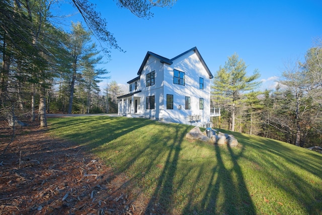 view of side of property with a lawn