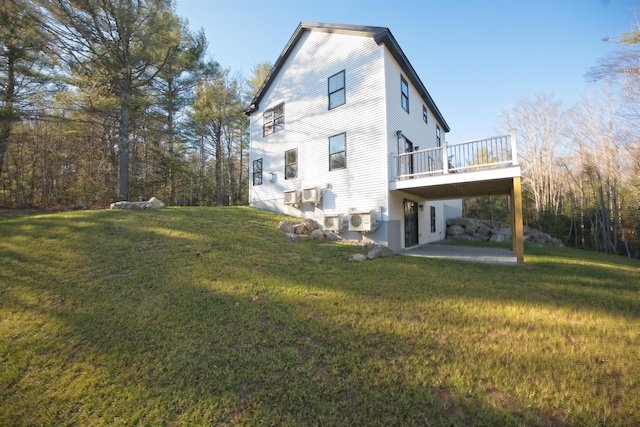 back of property with a yard, a patio, and a deck