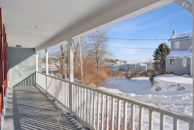 view of snow covered back of property