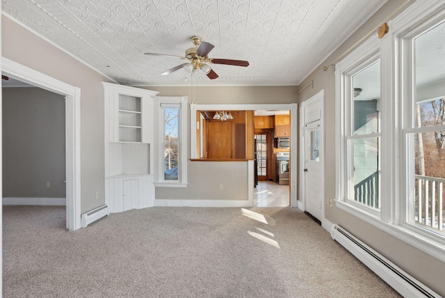 carpeted empty room with baseboards, a ceiling fan, and a baseboard radiator