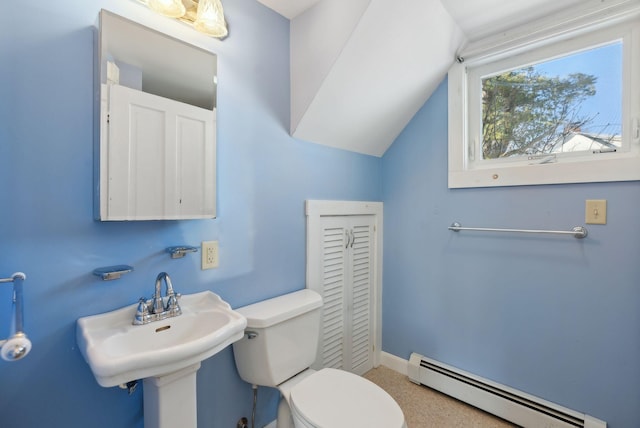 half bathroom with toilet, a sink, a baseboard heating unit, baseboards, and vaulted ceiling