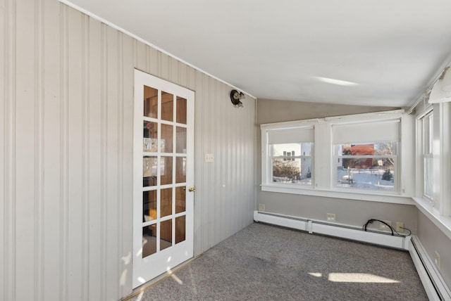 unfurnished sunroom featuring lofted ceiling and a baseboard radiator