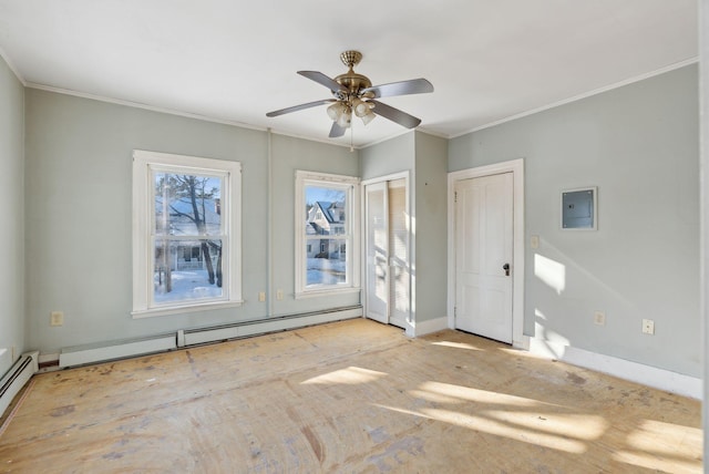 empty room with a baseboard heating unit, baseboards, ceiling fan, and crown molding