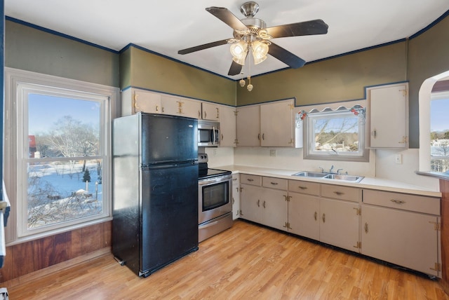 kitchen with light countertops, a wealth of natural light, and stainless steel appliances