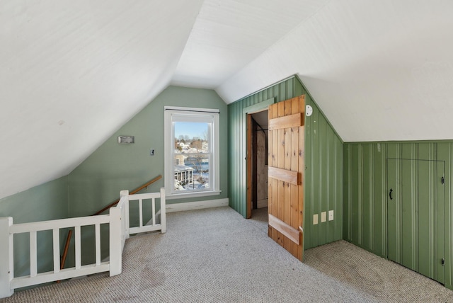 additional living space with carpet floors and vaulted ceiling