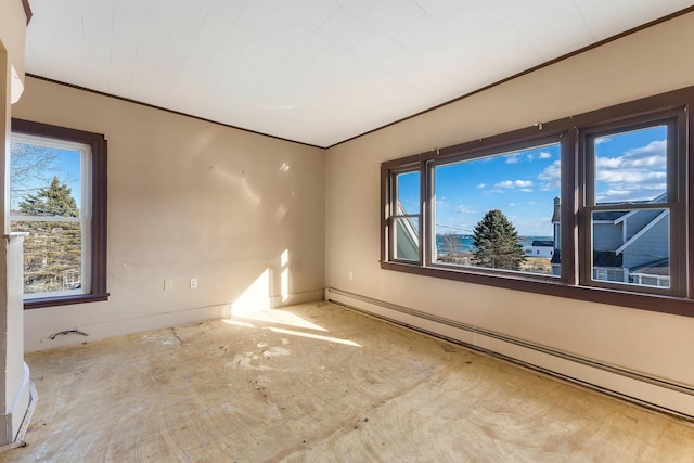 empty room featuring crown molding and baseboard heating