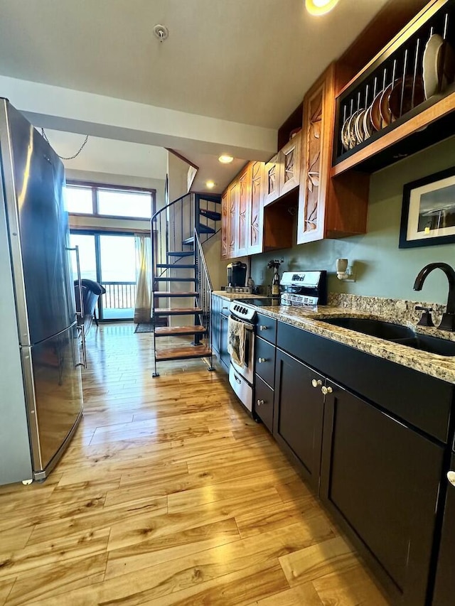 17-3 S Branch Way Unit 35, Sandy River Plt, ME 04970 - kitchen featuring stainless steel appliances, light stone counters, and light wood finished floors