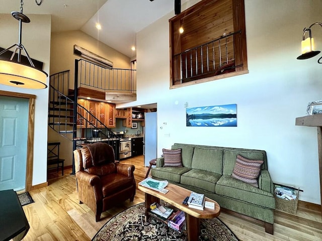 17-3 S Branch Way Unit 35, Sandy River Plt, ME 04970 - living area with high vaulted ceiling, light wood-type flooring, and stairs