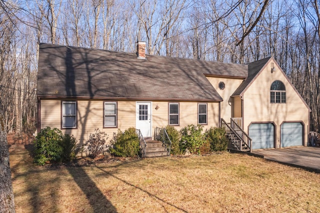 view of front of property featuring a garage and a front yard