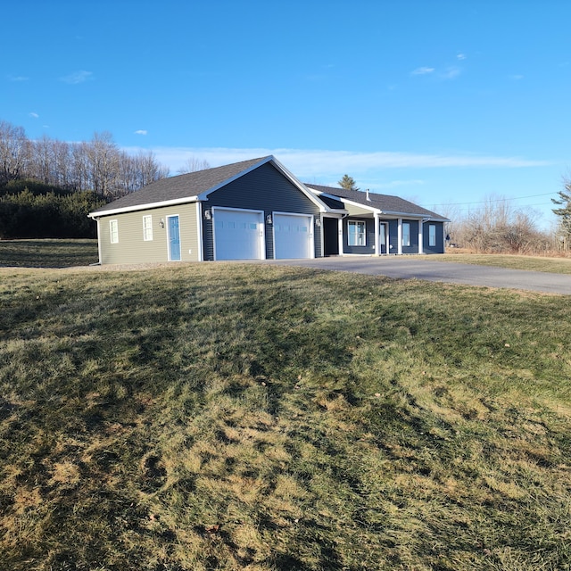 single story home with a front yard and a garage