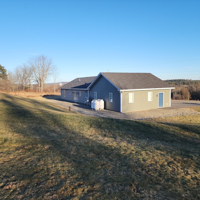 back of property featuring a lawn