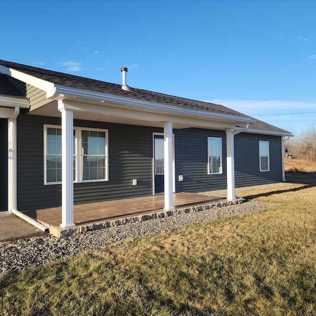 view of side of home with a yard