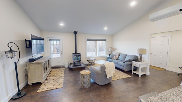 living room with lofted ceiling, dark hardwood / wood-style floors, a wood stove, and an AC wall unit