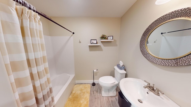 bathroom featuring toilet and wood-type flooring