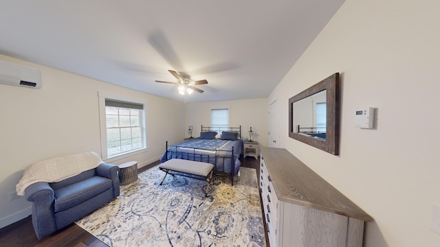 bedroom featuring a wall mounted air conditioner, hardwood / wood-style floors, and ceiling fan