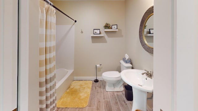 full bathroom with shower / bath combination with curtain, toilet, and sink