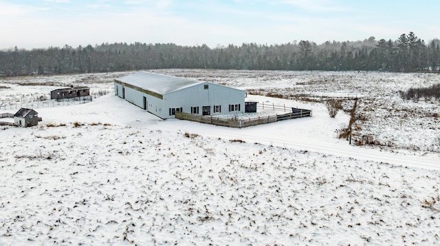 snowy aerial view with a view of trees