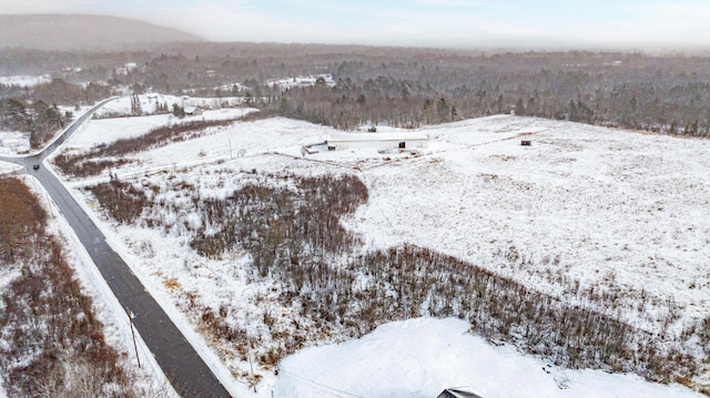 snowy aerial view with a mountain view