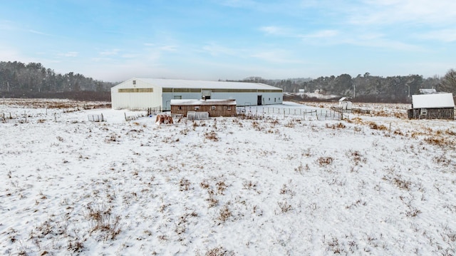 snow covered house with an outbuilding and a detached garage