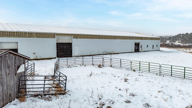 exterior space featuring a detached garage and an outbuilding