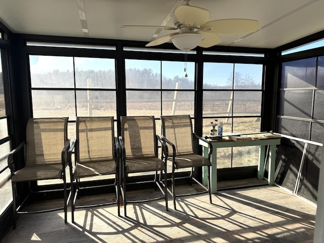 unfurnished sunroom with ceiling fan