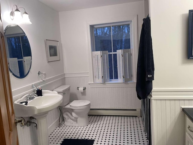 bathroom featuring sink, a baseboard radiator, and toilet