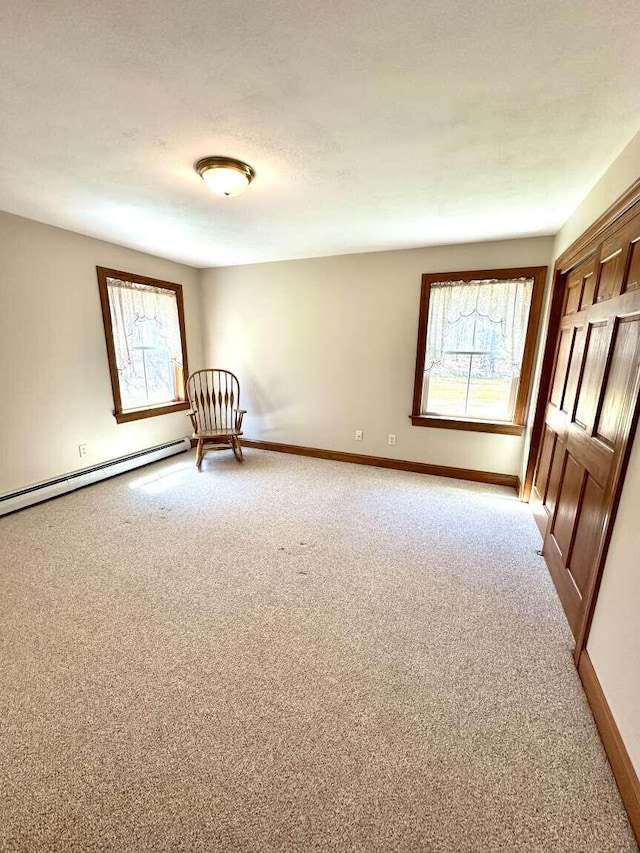 281 Danville Corner Rd, Auburn, ME 04210 - interior space featuring baseboards, light carpet, and a baseboard radiator