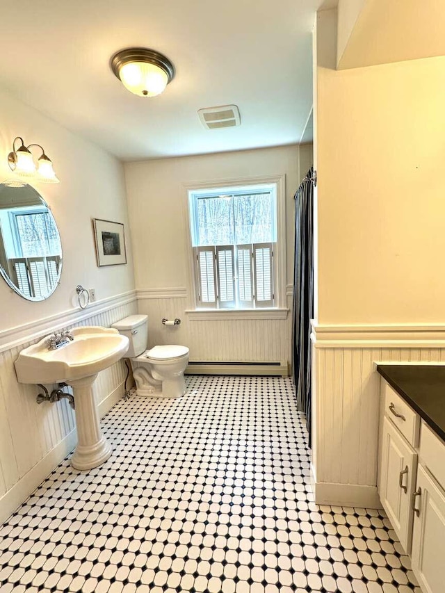 281 Danville Corner Rd, Auburn, ME 04210 - bathroom featuring a wainscoted wall, a wealth of natural light, and toilet