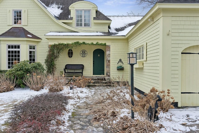 view of snow covered property entrance