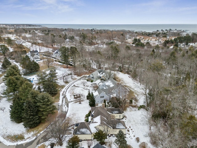 snowy aerial view featuring a water view