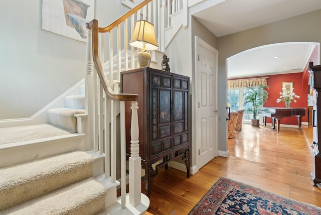 staircase with hardwood / wood-style floors