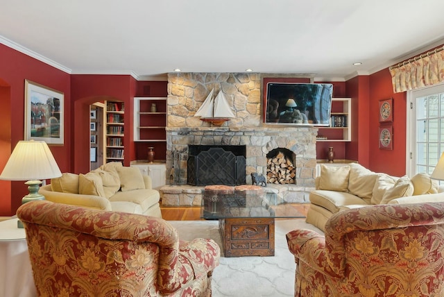 living room featuring hardwood / wood-style flooring, ornamental molding, and a stone fireplace