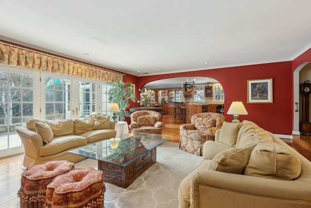 tiled living room featuring french doors and crown molding