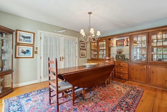 dining room with an inviting chandelier and light hardwood / wood-style flooring