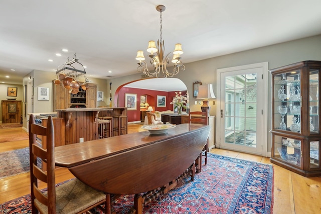 dining room with a notable chandelier and light wood-type flooring