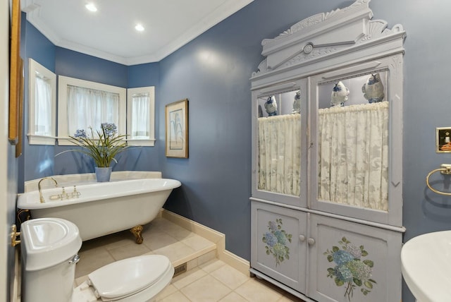 bathroom with a tub to relax in, ornamental molding, toilet, and tile patterned flooring