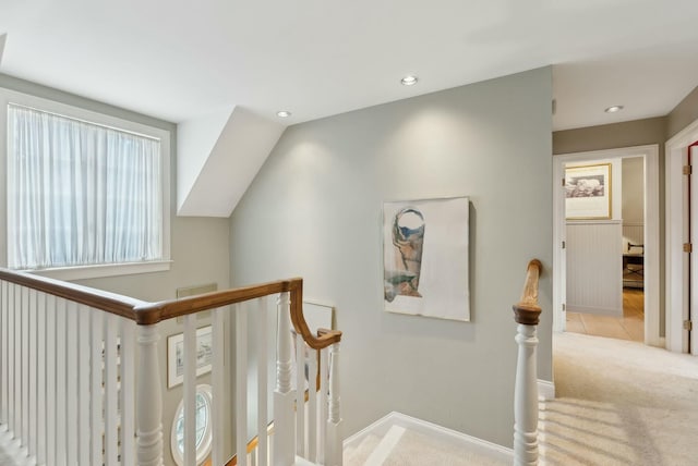 stairway with vaulted ceiling and carpet