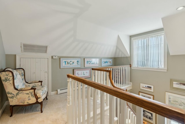 corridor with light colored carpet and a baseboard radiator