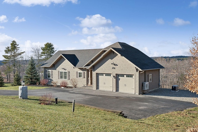 view of front of house with a front yard and a garage