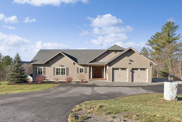 view of front of property featuring a garage and a front lawn