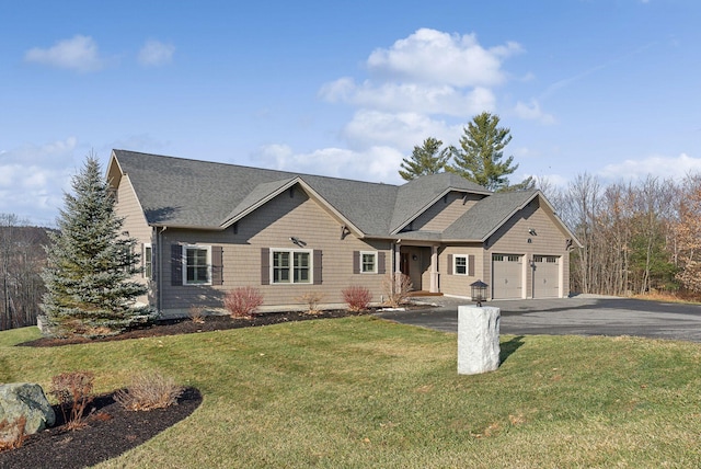 view of front of house featuring a front yard and a garage