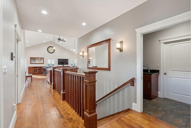 hall featuring sink, lofted ceiling, and hardwood / wood-style flooring