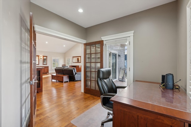 office space with french doors, light hardwood / wood-style floors, and vaulted ceiling