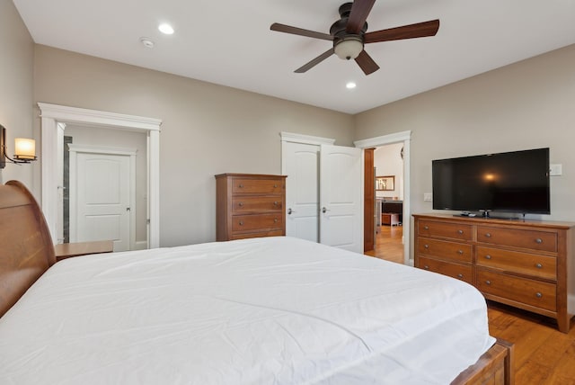 bedroom with ceiling fan and light wood-type flooring