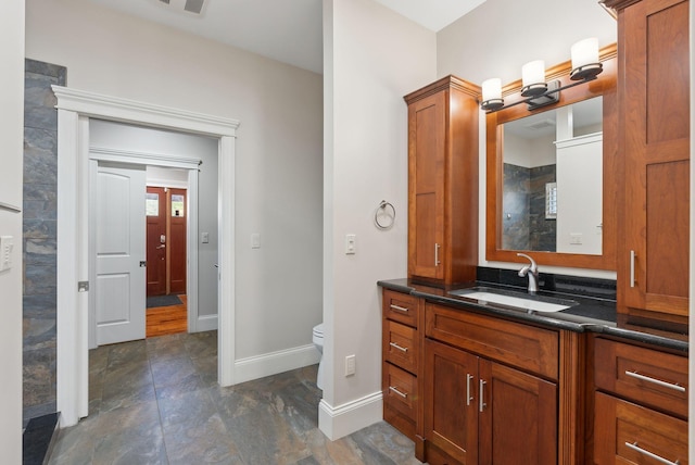 bathroom featuring vanity and toilet