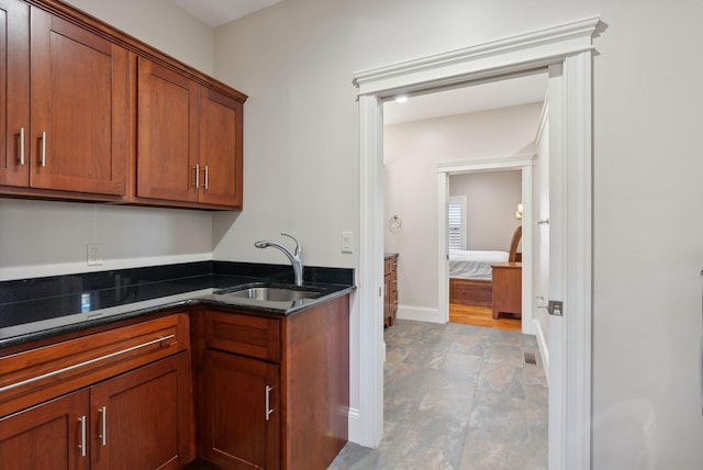 kitchen featuring sink and dark stone counters